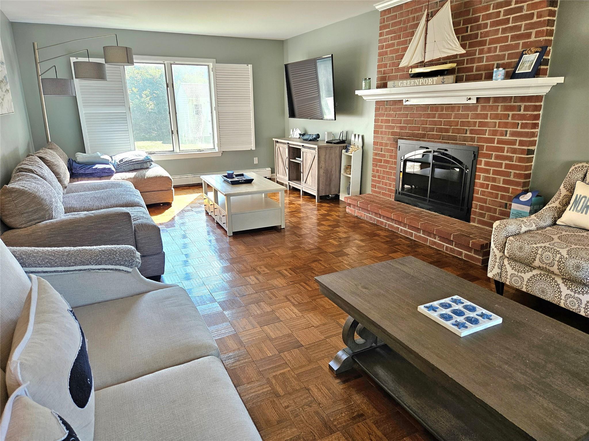 3650 Bay Shore Road Greenport, NY 11944 - Photo 15 of 30 a living room with furniture fireplace and a flat screen tv