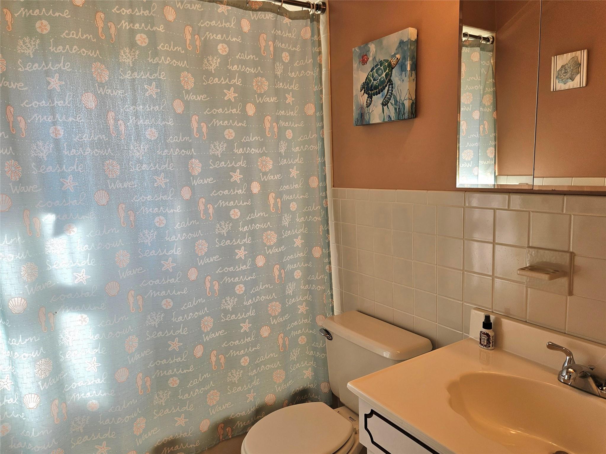 3650 Bay Shore Road Greenport, NY 11944 - Photo 28 of 30 a bathroom with a sink and a mirror