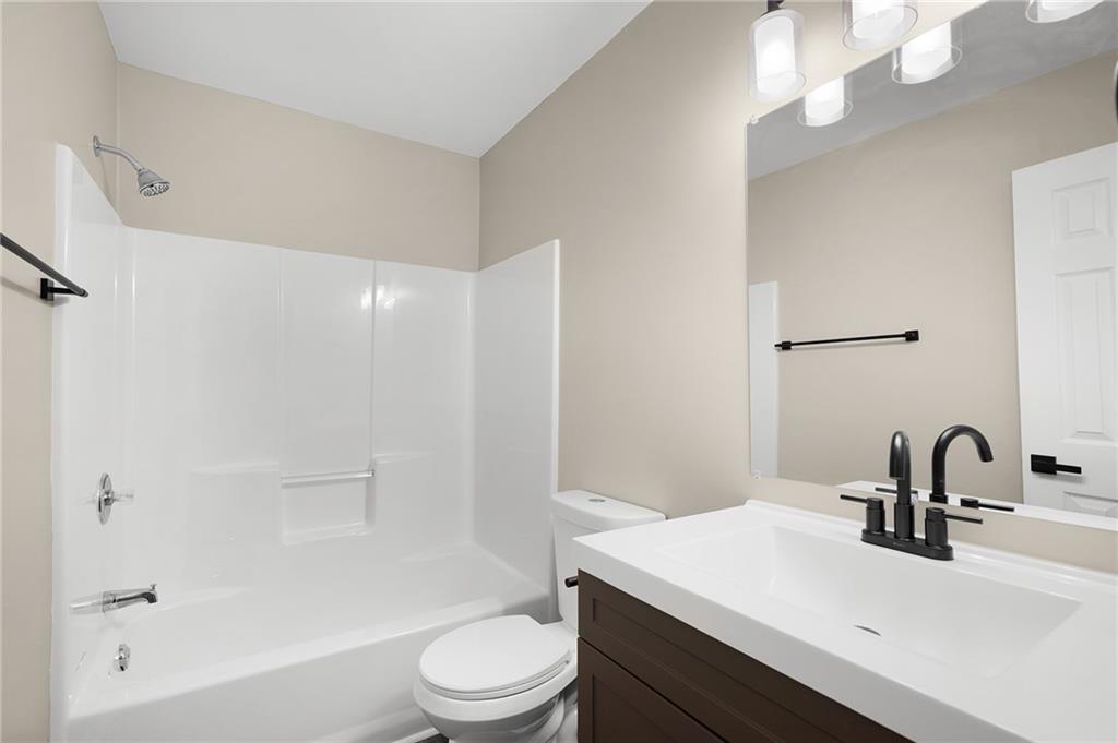 789 Buck Boulevard Southeast Calhoun, GA 30701 - Photo 11 of 14 a bathroom with a sink a toilet and shower