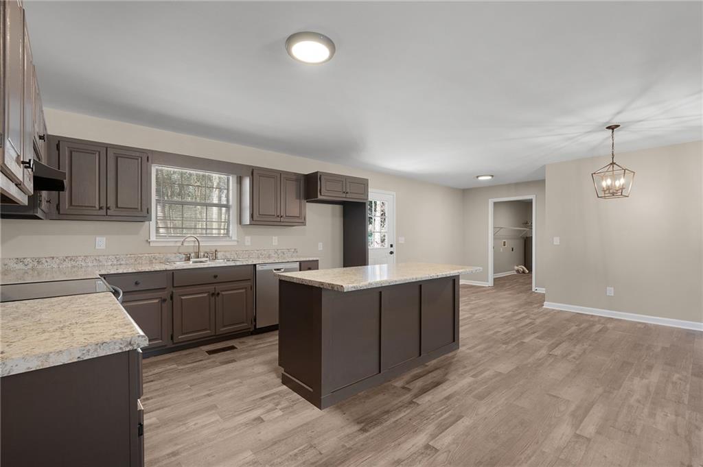 789 Buck Boulevard Southeast Calhoun, GA 30701 - Photo 4 of 14 a kitchen with sink a stove and cabinets