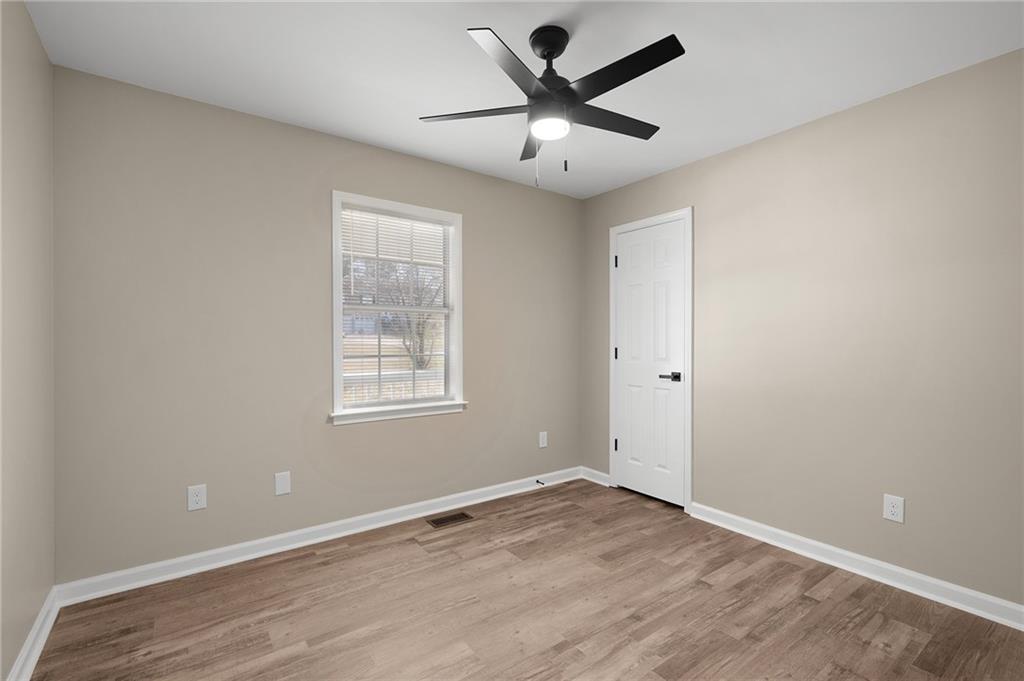 789 Buck Boulevard Southeast Calhoun, GA 30701 - Photo 7 of 14 an empty room with a window and a fan