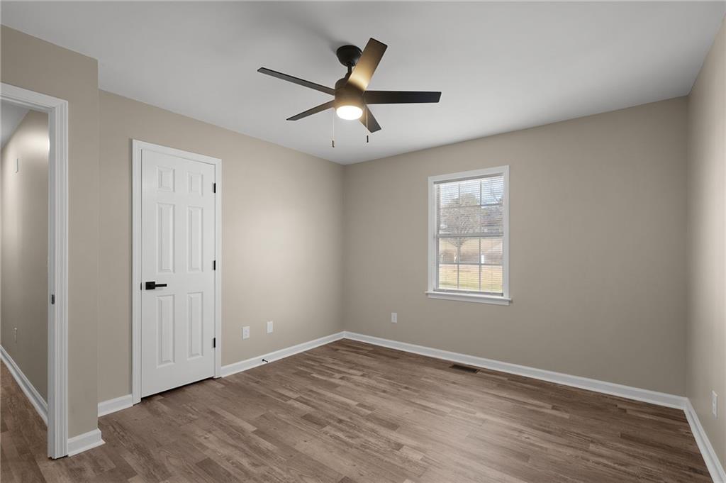 789 Buck Boulevard Southeast Calhoun, GA 30701 - Photo 9 of 14 a view of empty room with wooden floor and fan