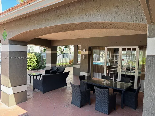 a view of swimming pool with seating space and plants