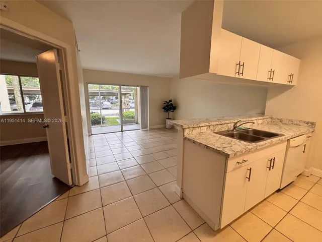 a bathroom with a granite countertop sink a toilet and vanity