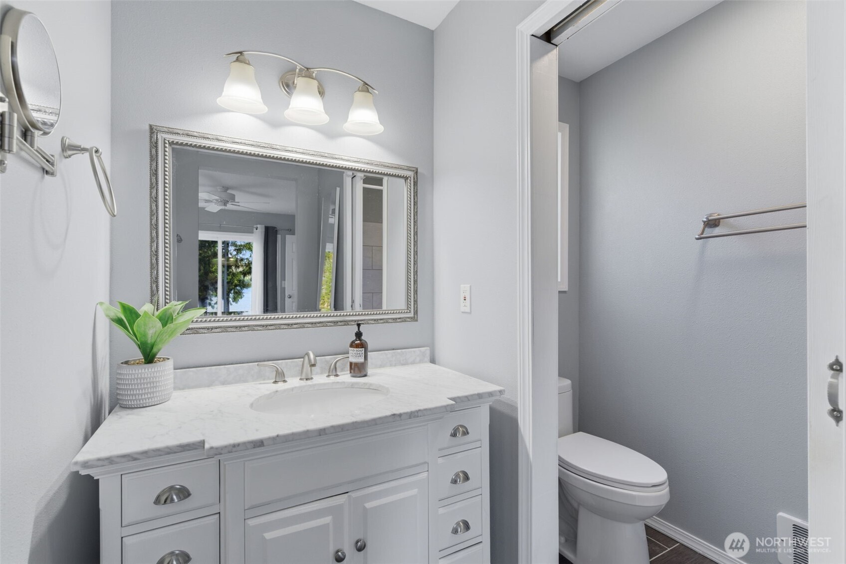 6971 Northeast Tahuya Blacksmith Road Belfair, WA 98528 - Photo 24 of 38 a bathroom with a granite countertop sink a toilet and a mirror