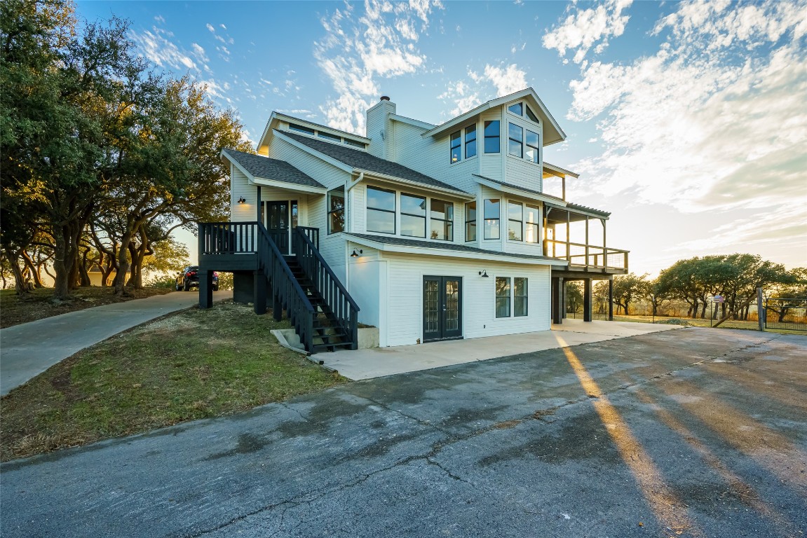 Undisclosed Address Dripping Springs, TX 78620 - Photo 1 of 19 a front view of a house with a yard