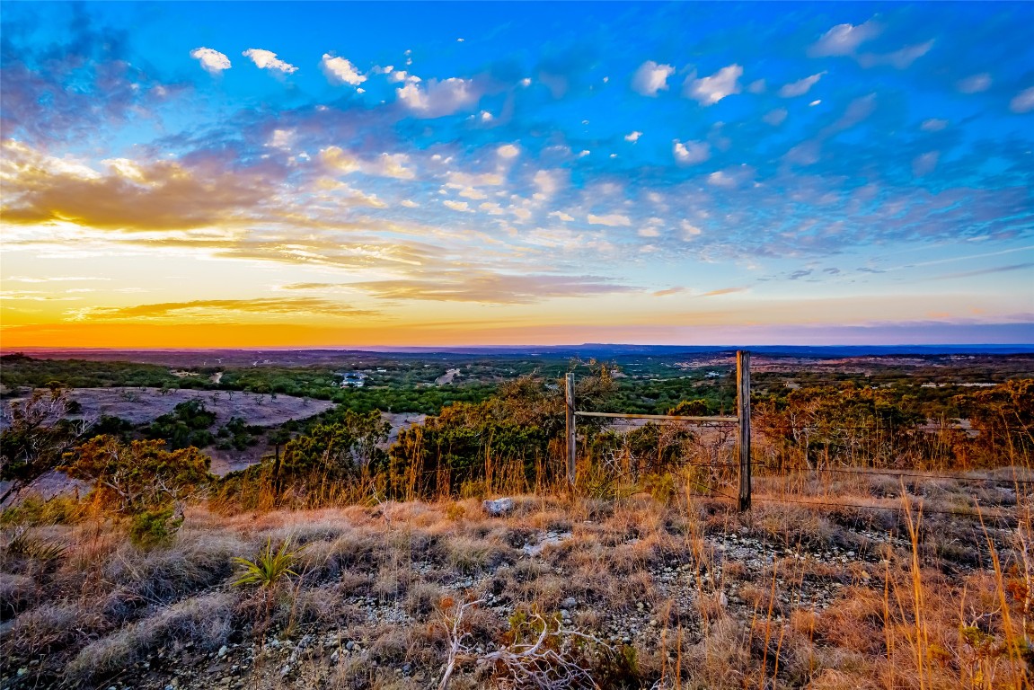 Undisclosed Address Dripping Springs, TX 78620 - Photo 17 of 19 a view of a lake with a yard