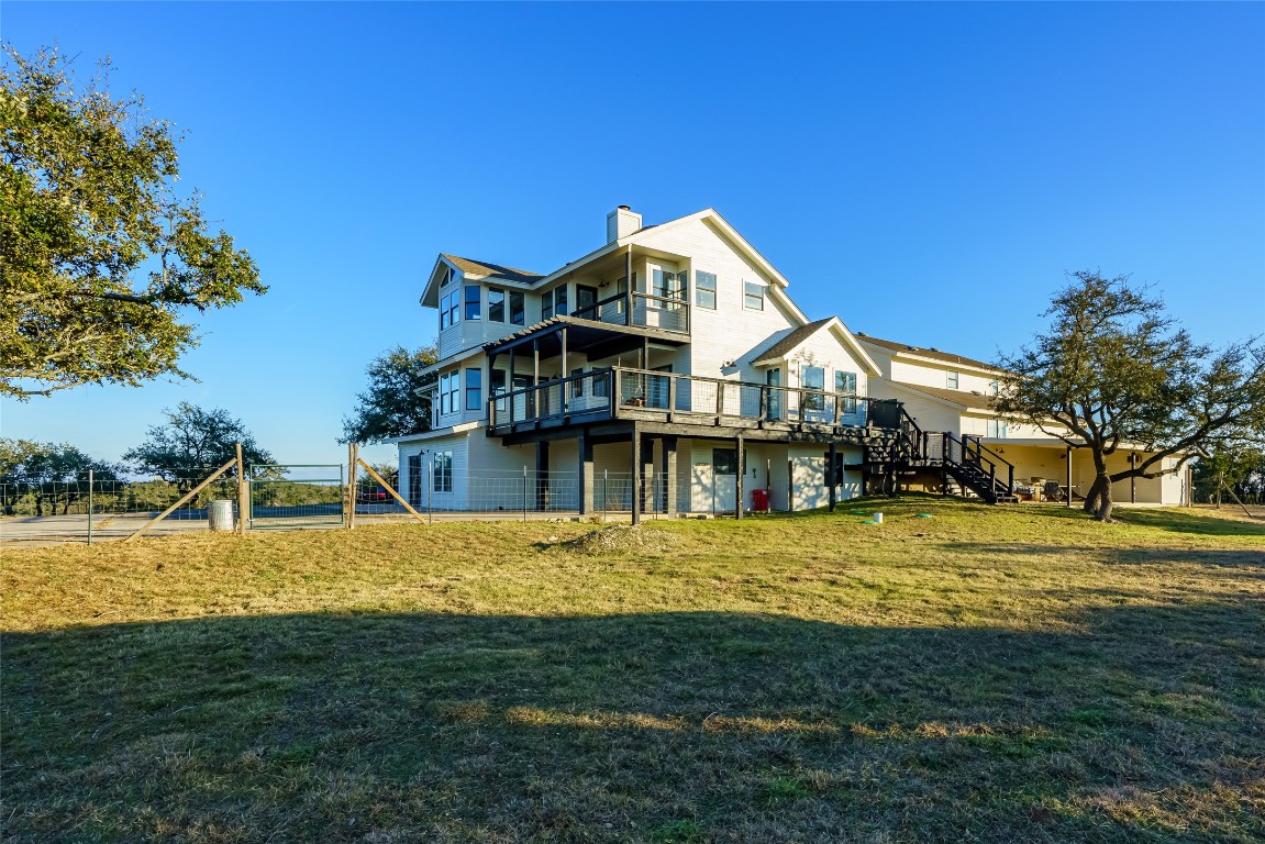 Undisclosed Address Dripping Springs, TX 78620 - Photo 2 of 19 a view of a house next to a big yard with large trees