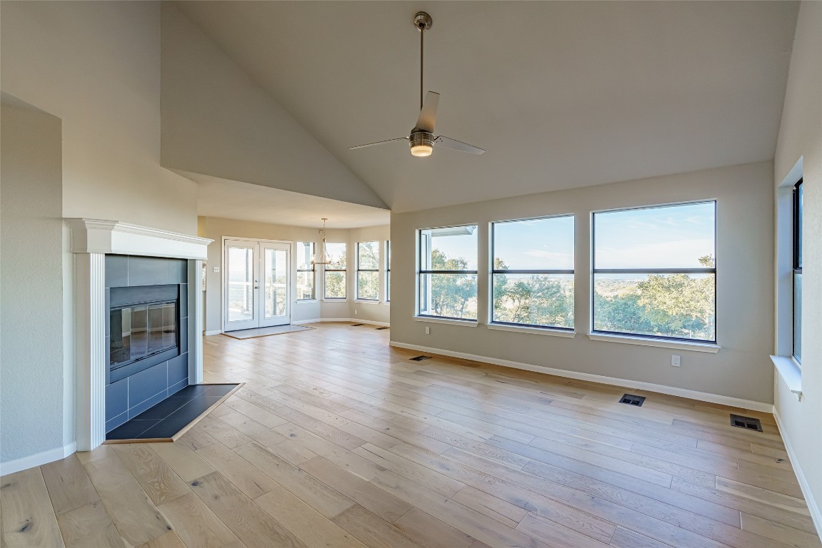 Undisclosed Address Dripping Springs, TX 78620 - Photo 3 of 19 a view of an empty room with wooden floor and a window