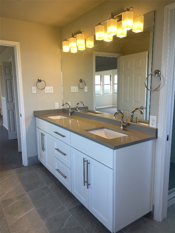 Undisclosed Address Dripping Springs, TX 78620 - Photo 9 of 19 a bathroom with a granite countertop sink and a mirror