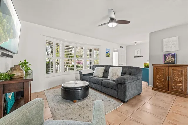 a kitchen with stainless steel appliances granite countertop a stove top oven a refrigerator a sink and dishwasher with white cabinets