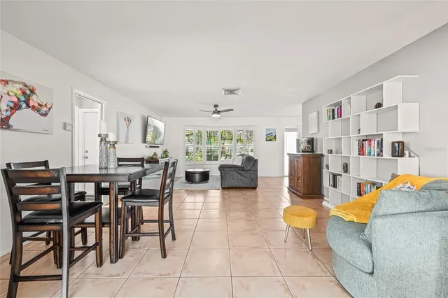 a kitchen with stainless steel appliances granite countertop a stove top oven a sink a refrigerator and white cabinets