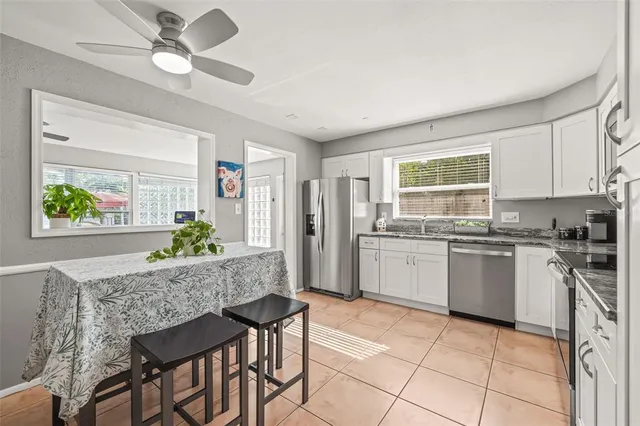 a kitchen with granite countertop cabinets stainless steel appliances and a sink