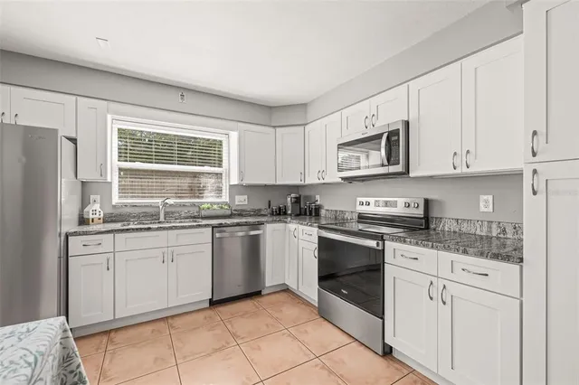 a bedroom with a large bed and a chair