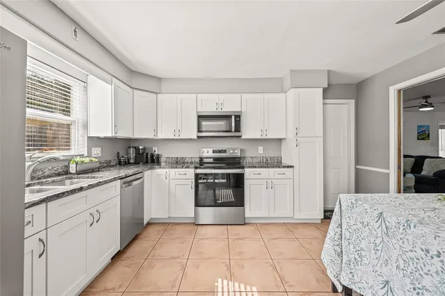 a bathroom with a granite countertop sink mirror vanity and toilet
