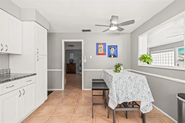 a bedroom with a bed chandelier and a window