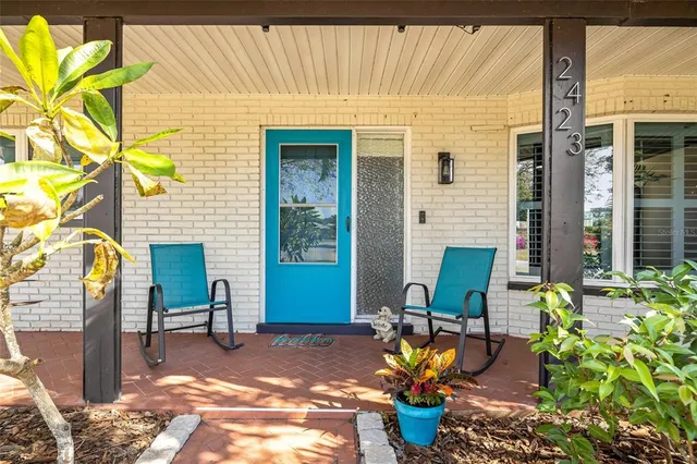 a living room with furniture and a view of kitchen