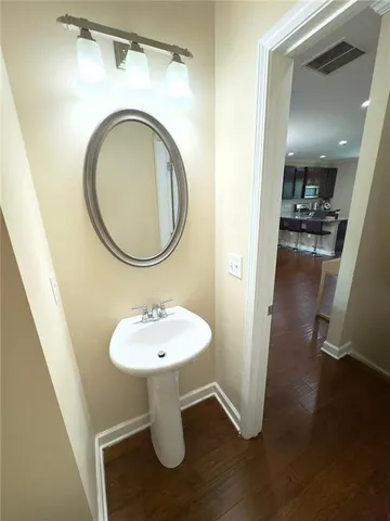 a bathroom with a sink toilet and a mirror