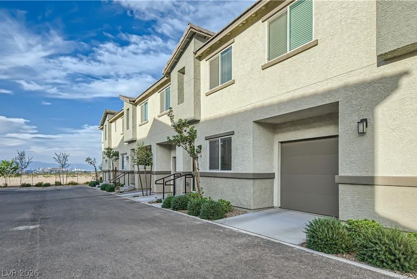 12110 Midnight Pine Road, Unit 3 Las Vegas, NV 89183 - Photo 12 of 13 A contemporary row of townhomes presents clean lines and individual garage access.