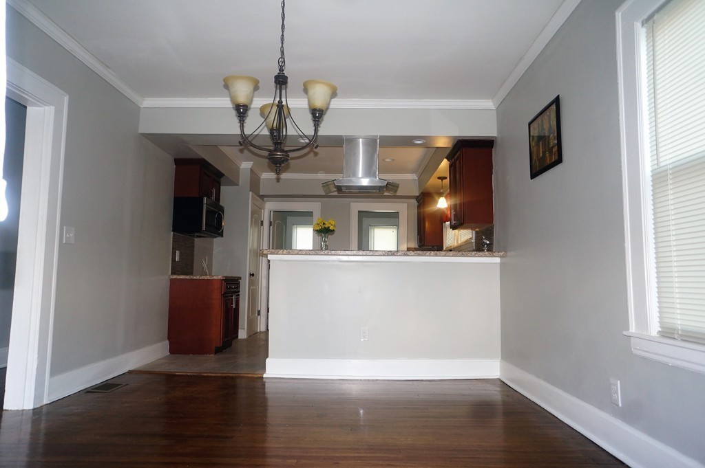 38 Fenwick Street Springfield, MA 01109 - Photo 17 of 28 a view of a living room with wooden floor and chandelier