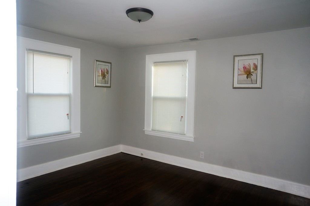 38 Fenwick Street Springfield, MA 01109 - Photo 25 of 28 an empty room with wooden floor and windows