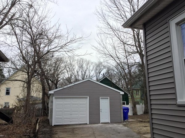38 Fenwick Street Springfield, MA 01109 - Photo 4 of 28 a front view of a house with a yard and garage