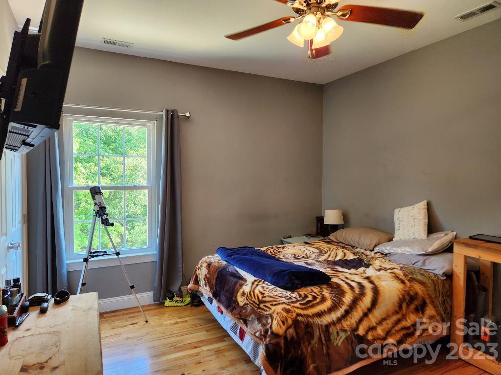 2326 Center Road Chester, SC 29706 - Photo 26 of 42 a bedroom with a bed and a chandelier