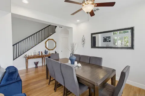 a view of a dining room with furniture a chandelier and wooden floor