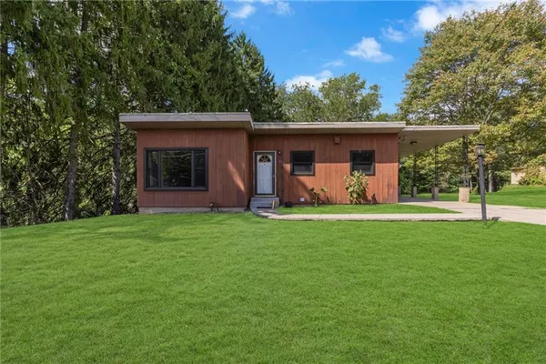 a front view of house with yard and outdoor seating