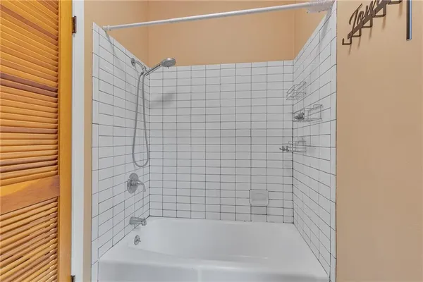 a view of a hallway with wooden floor and stairs