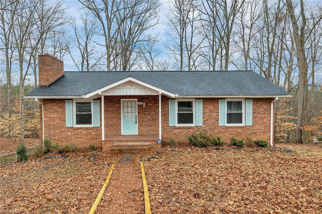 795 Dan Valley Road Madison, NC 27025 - Photo 1 of 38 Visualization & feeling are key to your Successful Home buying experience. As you look at these pictures feel how nice it would be living here, knowing that "It's So Good to be 'Home’. It feels like HOME when you see yourself in every picture. Here we have a Front View showing the covered front porch, the low maintenance brick exterior, the mature trees and some fresh landscaping pine straw.