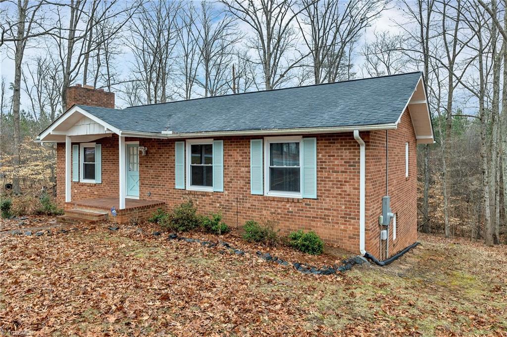 795 Dan Valley Road Madison, NC 27025 - Photo 11 of 38 Front Right View: Here we can see the low maintenance brick exterior and the mature trees.