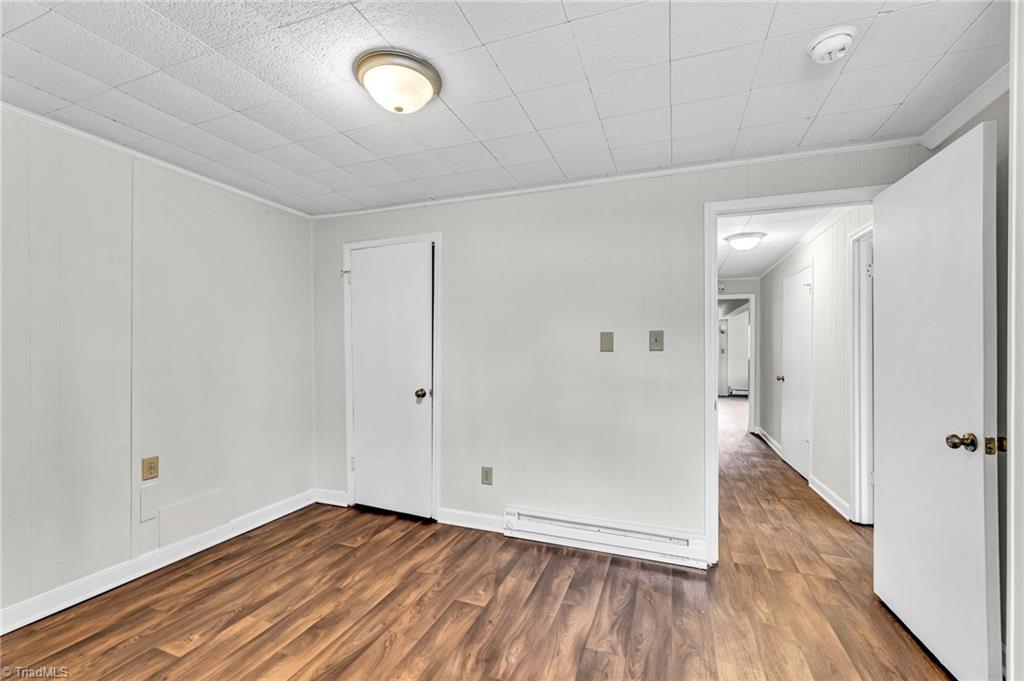 795 Dan Valley Road Madison, NC 27025 - Photo 32 of 38 Basement Office: Features include new vinyl plank flooring for easy cleaning, a window for natural lighting, fresh paint and a storage closet to the left side and the entry door in on the right side. .