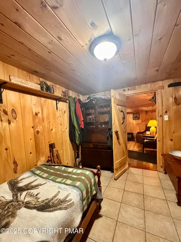 a bedroom with furniture and a large window