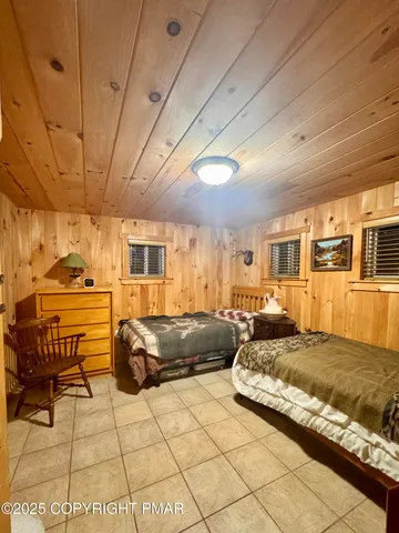 a bedroom with a bed and wooden cabinets