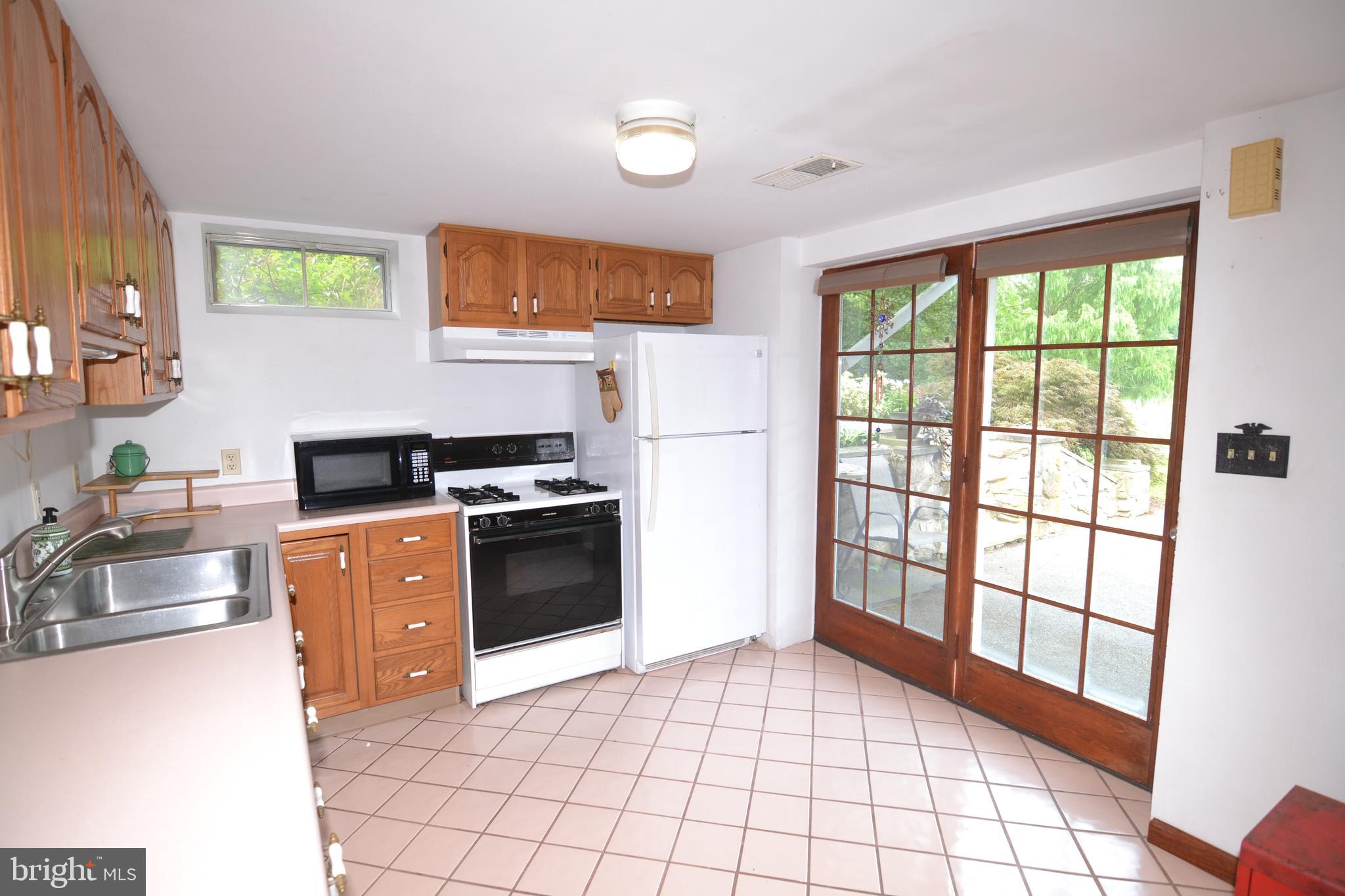 329 Isabella Road Elverson, PA 19520 - Photo 44 of 73 In-Law suite kitchen with french doors to driveway