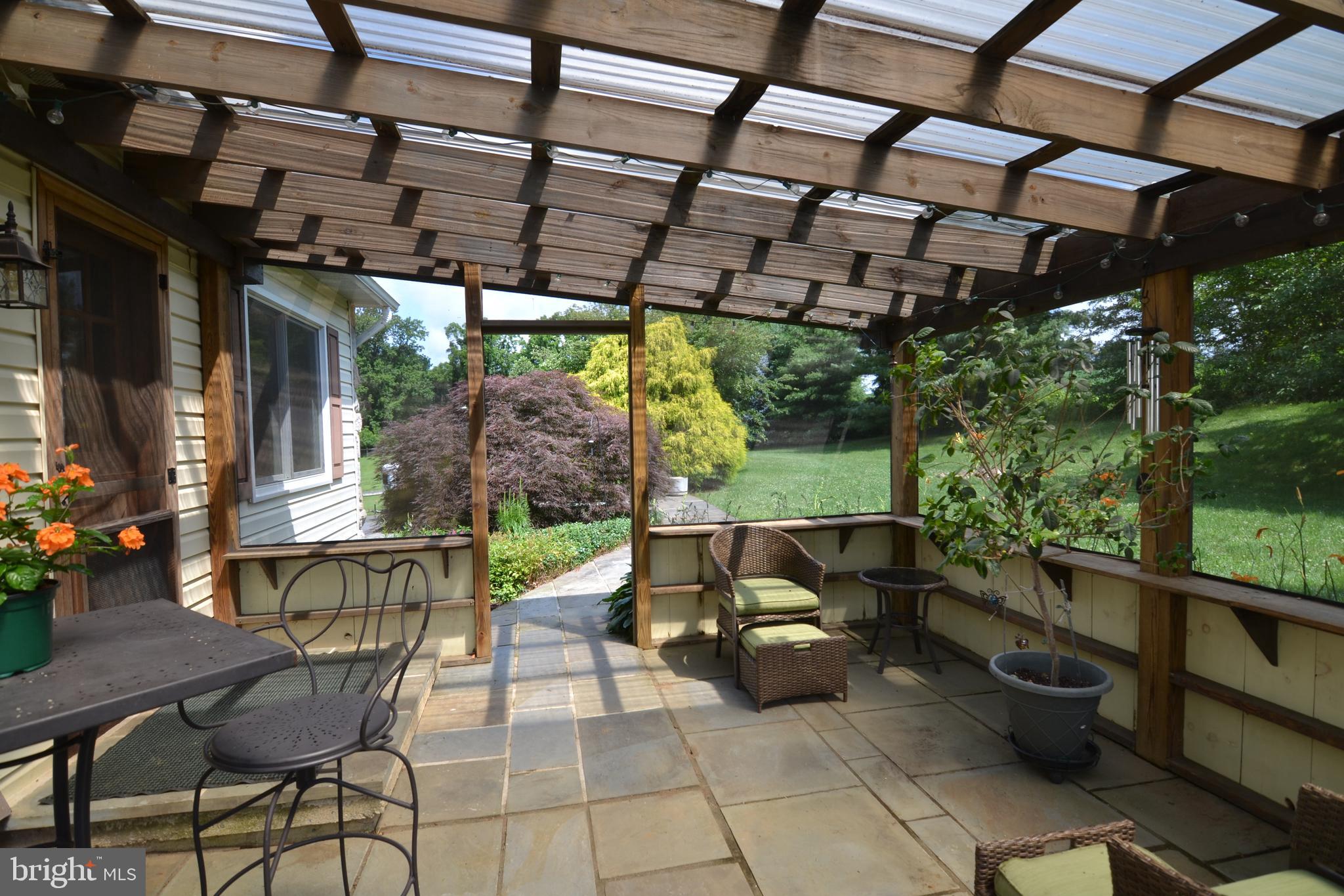 329 Isabella Road Elverson, PA 19520 - Photo 48 of 73 Screened in patio with slate