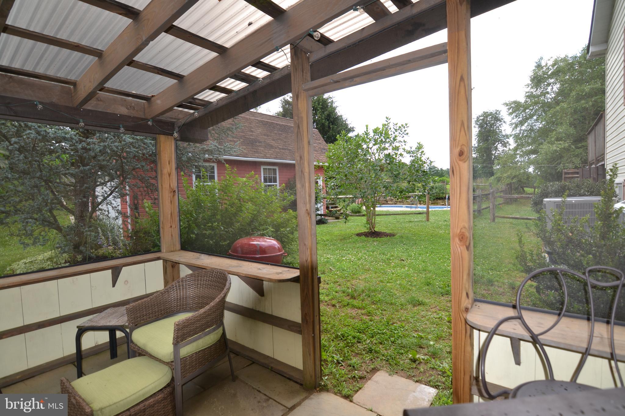 329 Isabella Road Elverson, PA 19520 - Photo 49 of 73 Screened in patio with view of pool