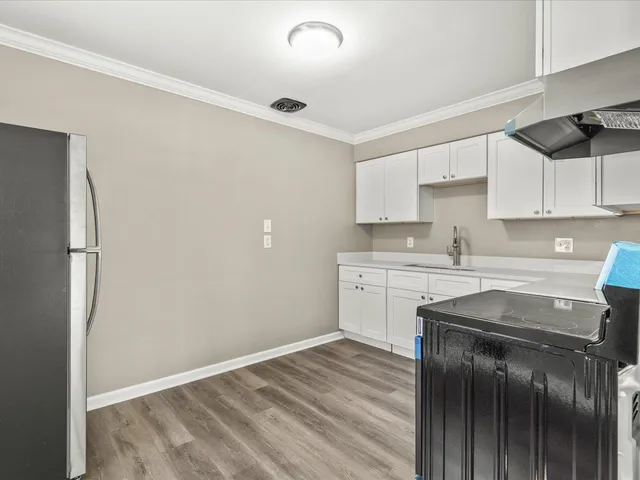 a kitchen with stainless steel appliances granite countertop a sink stove and cabinets