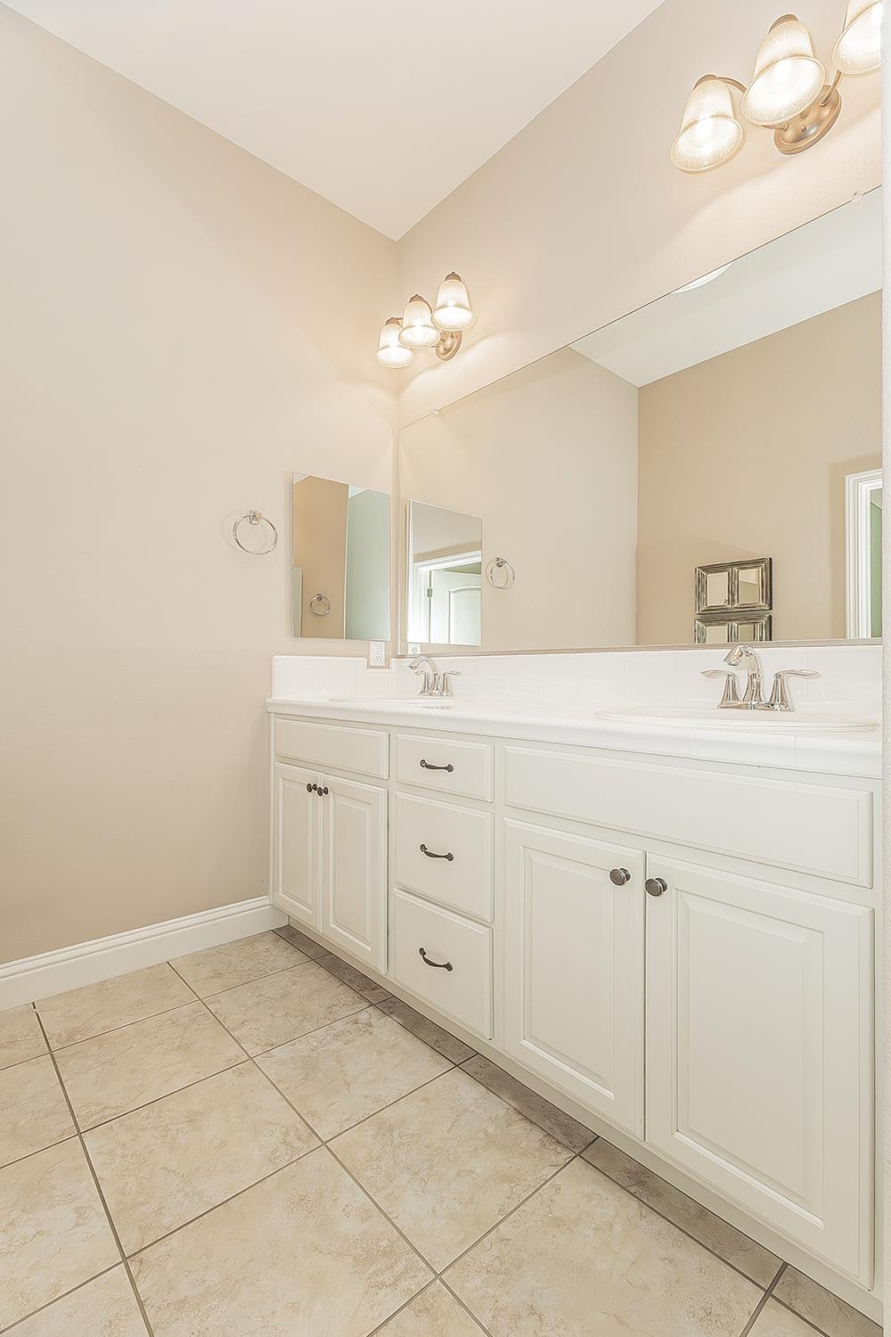 2047 South Church Avenue Reedley, CA 93654 - Photo 16 of 39 a spacious bathroom with a double vanity sink a mirror and a