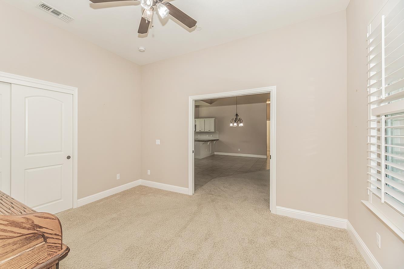2047 South Church Avenue Reedley, CA 93654 - Photo 25 of 39 an empty room with a ceiling fan and window