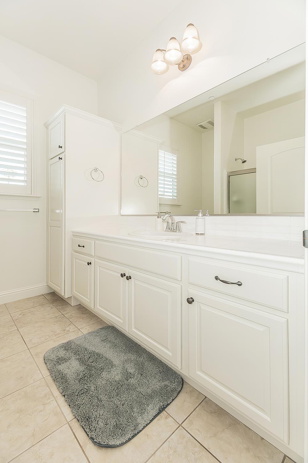 2047 South Church Avenue Reedley, CA 93654 - Photo 27 of 39 a bathroom with a sink a vanity and mirror