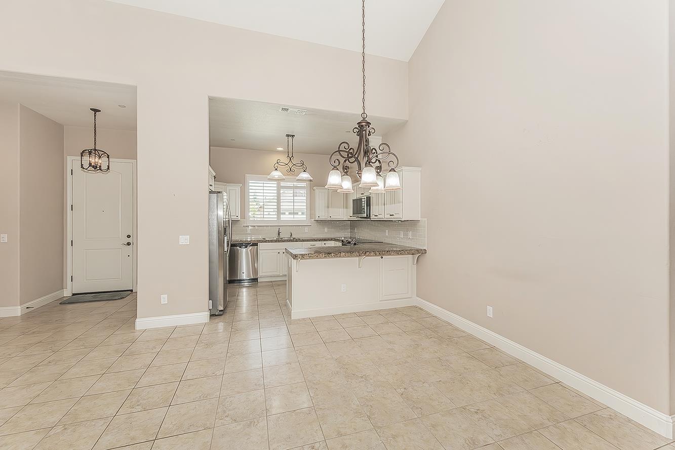2047 South Church Avenue Reedley, CA 93654 - Photo 3 of 39 a room with a chandelier and kitchen view