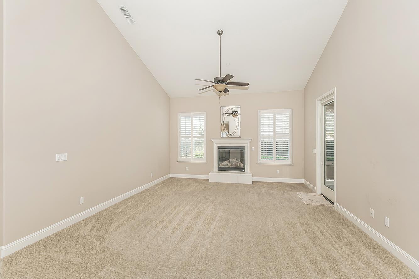 2047 South Church Avenue Reedley, CA 93654 - Photo 5 of 39 an empty room with fireplace and windows