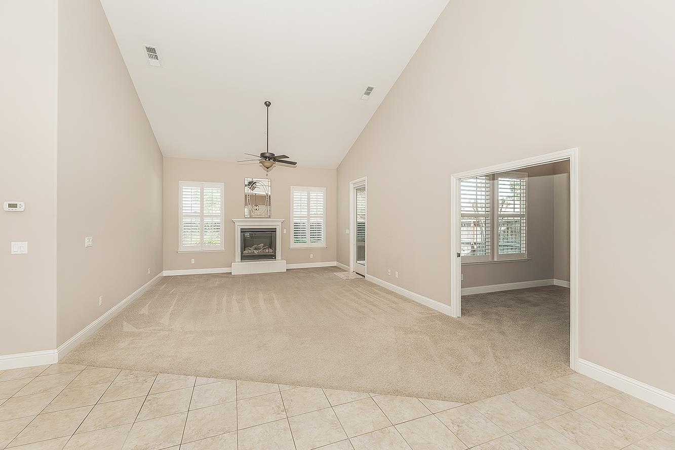 2047 South Church Avenue Reedley, CA 93654 - Photo 7 of 39 an empty room with large windows and fireplace