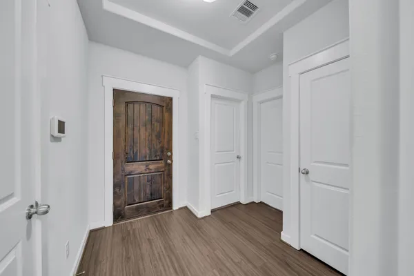 an empty room with wooden floor and closet