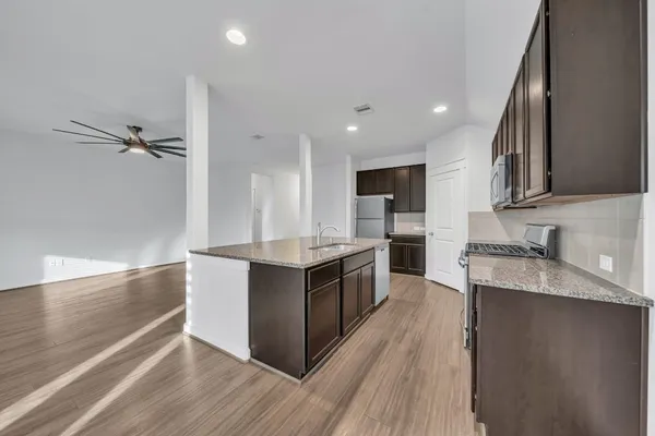 a large kitchen with stainless steel appliances lots of counter top space and cabinets