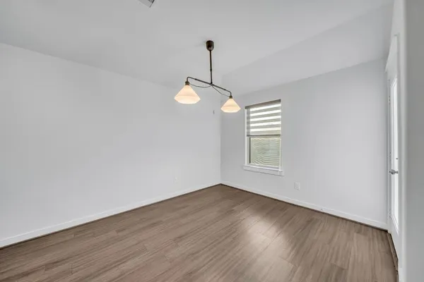 a view of wooden floor and windows in a room