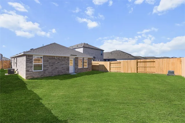 a view of a yard with a house in the background