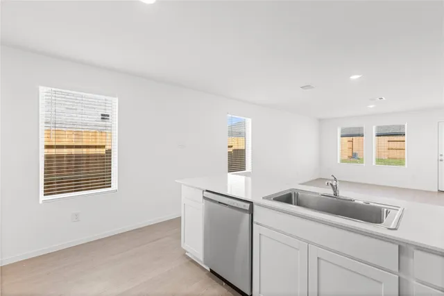 a kitchen with a sink cabinets and window